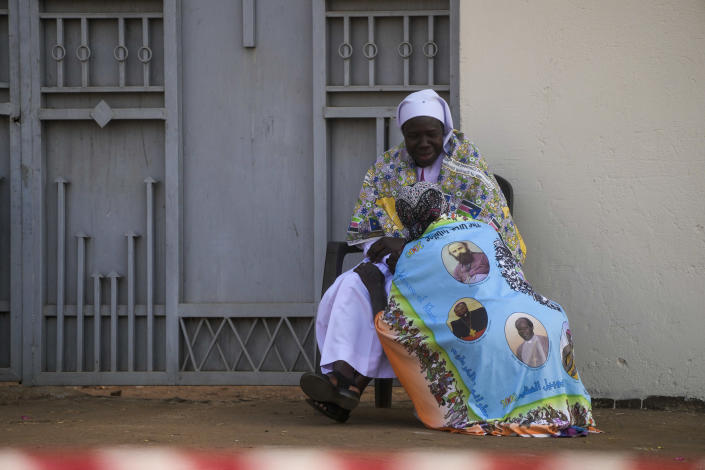 A woman waits for the arrival of Pope Francis for a meeting with priests, deacons, consecrated people and seminarians at the Cathedral of Saint Theresa in Juba, South Sudan, Saturday, Feb. 4, 2023. Francis is in South Sudan on the second leg of a six-day trip that started in Congo, hoping to bring comfort and encouragement to two countries that have been riven by poverty, conflicts and what he calls a "colonialist mentality" that has exploited Africa for centuries. (AP Photo/Gregorio Borgia)