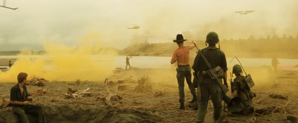 Yellow smoke rises on a beach