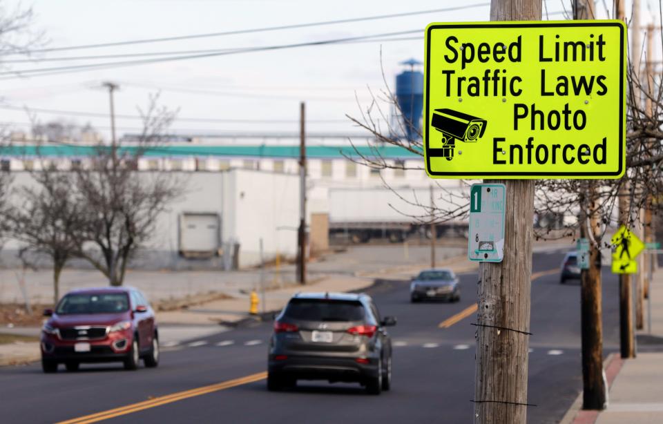 A speed camera warning sign on Division Street in Pawtucket between Joseph Jenks Junior High School and McCoy Stadium.