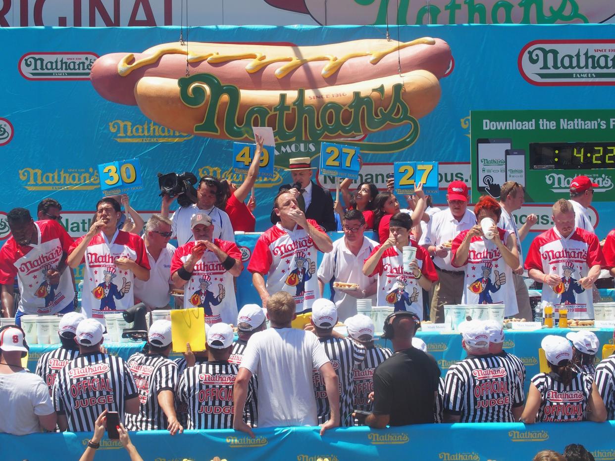 Joey "Jaws" Chestnut and Matt Stonie compete in the 2019 Nathans Famous Fourth of July International Hot Dog Eating Contest at Coney Island on July 4, 2019 in New York City.