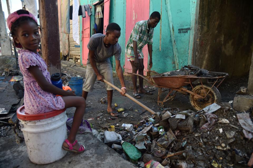 Residents clean debris on Oct. 8, 2016.