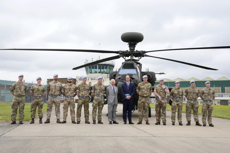 King Charles III poses with service personnel at the the Army Aviation Centre. Kin Cheung/WPA Pool/Shutterstock