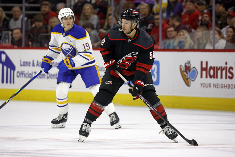 Michael Bunting (58) controls the puck near Buffalo Sabres' Peyton Krebs (19) during the first period of an NHL hockey game in Raleigh, N.C., Saturday, Dec. 2, 2023. (AP Photo/Karl B DeBlaker)