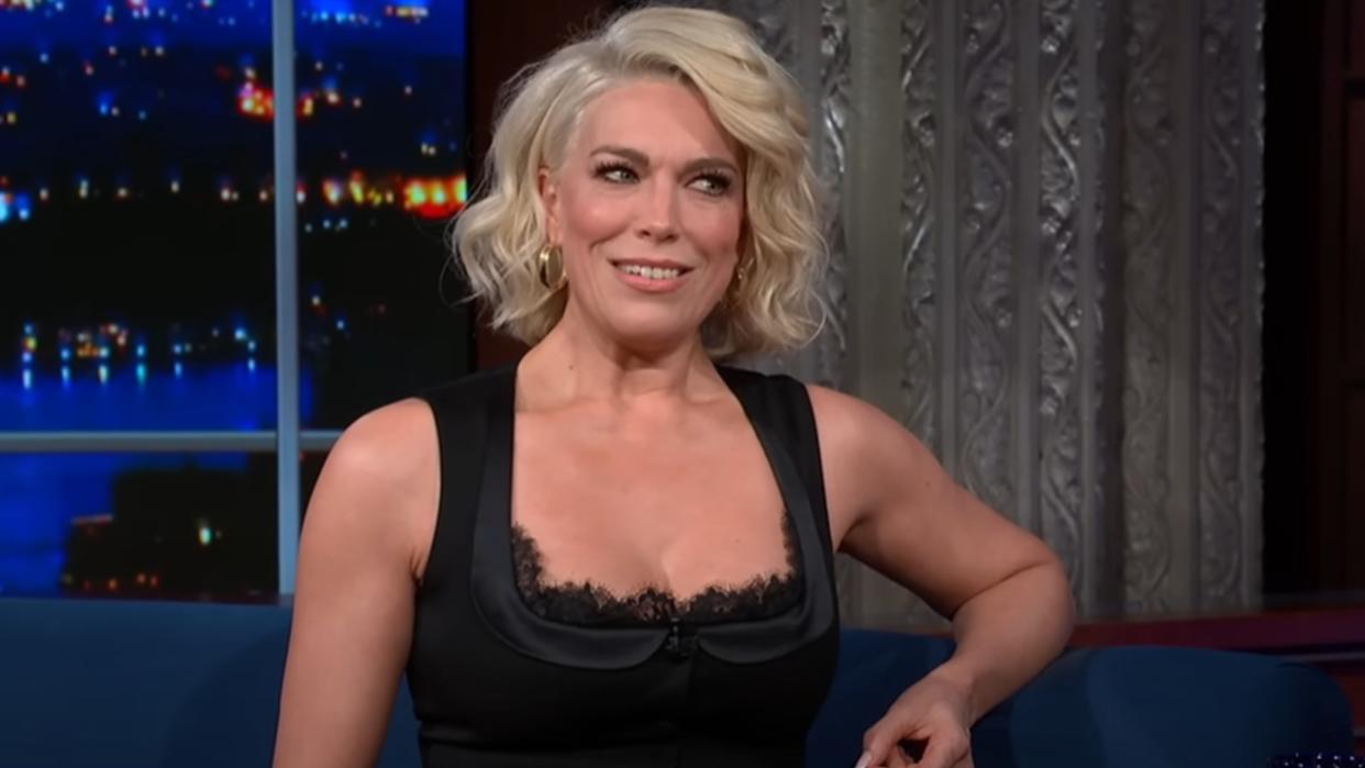  Hannah Waddingham smiling on Stephen Colbert's talk show. 