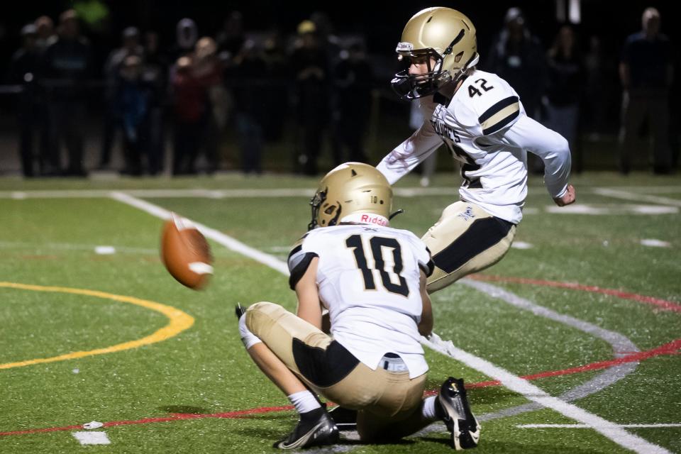 Delone Catholic's Nolan Kruse (42) kicks a 24-yard field goal to win the game for the Squires in double overtime against York Catholic at York Catholic Stadium on Friday, September 30, 2022.
