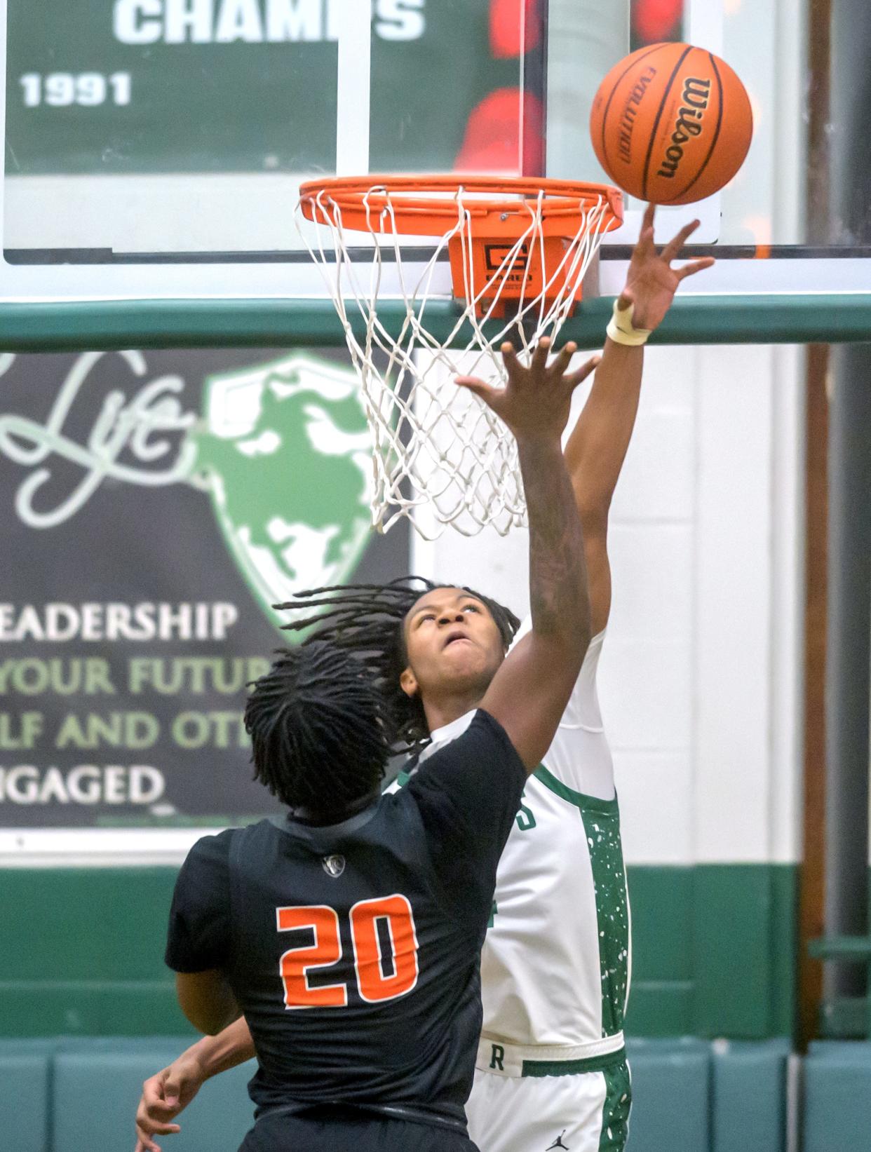 Richwoods' Tavie Smith, facing, defends against a shot from Manual's Jakyle Green in the second half of their Big Twelve Conference basketball game Tuesday, Dec. 5, 2023 at Richwoods High School. The Knights defeated the Rams 73-51.