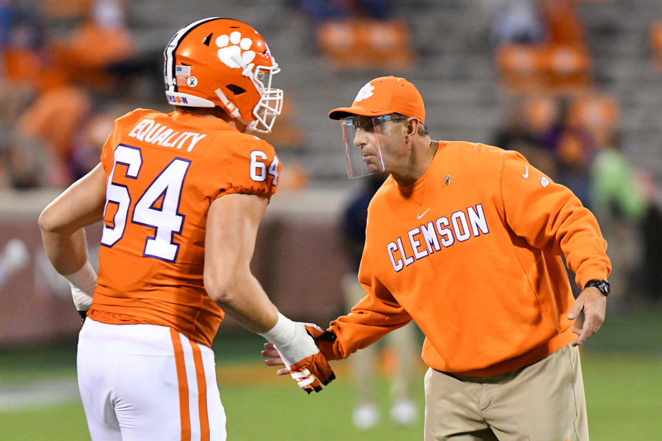 CLEMSON, SC - OCTOBER 03: Clemson Tigers head coach Dabo Swinney high fives Clemson Tigers offensive lineman Walker Parks (64) during pregame practice for the game between the Clemson Tigers and the Virginia Cavaliers on October 03, 2020 at Memorial Stadium in Clemson, South Carolina. (Photo by Dannie Walls/Icon Sportswire via Getty Images)