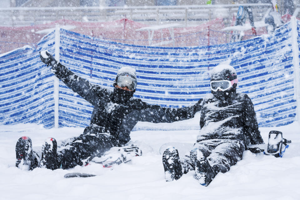 Skiers sit in the snow at Big Mountain Resort Saturday, March 30, 2024, in Big Bear Lake, Calif. (Big Mountain Resort via AP)