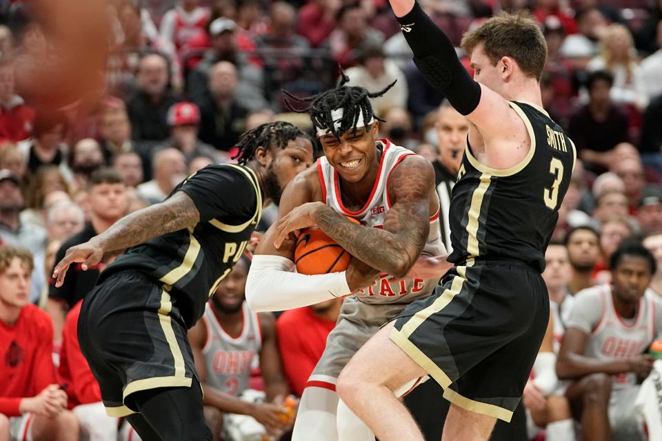 Jan 5, 2023; Columbus, OH, USA;  Ohio State Buckeyes guard Eugene Brown III (3) muscles between Purdue Boilermakers guard David Jenkins Jr. (14) and guard Braden Smith (3) during the NCAA men's basketball game at Value City Arena. Purdue won 71-69. Mandatory Credit: Adam Cairns-The Columbus Dispatch