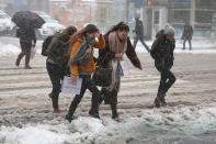 <p>Pedestrians face high winds and snow as they cross the street in Times Square in New York, Feb. 9, 2017. (Gordon Donovan/Yahoo News) </p>