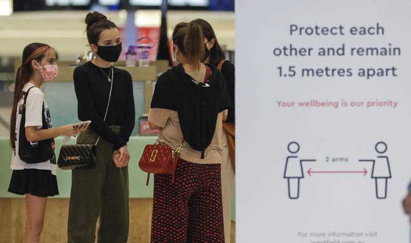 Shoppers wear masks as they walk around a shopping precinct in Sydney.