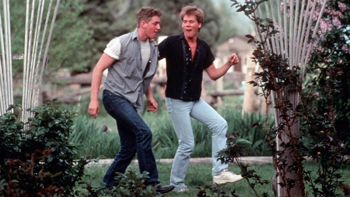 Ren, played by Kevin Bacon, teaches his friend Willard, Christopher Penn, to dance.