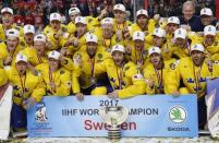 Ice Hockey - 2017 IIHF World Championship - Gold medal game - Canada v Sweden - Cologne, Germany - 22/5/17 - Members of team Sweden pose for a picture with the trophy. REUTERS/Grigory Dukor
