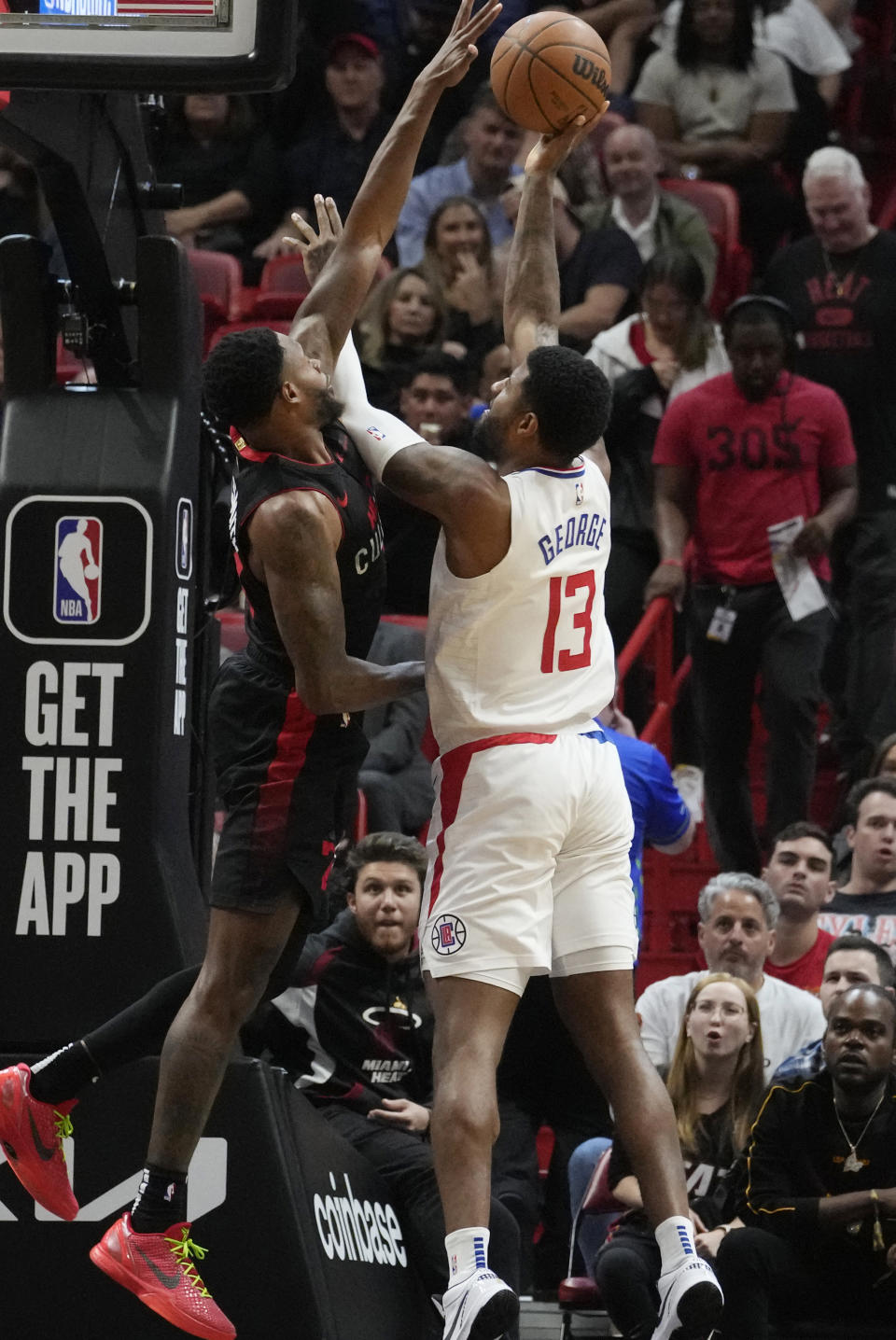 LA Clippers forward Paul George (13) aims to score asMiami Heat forward Jimmy Butler (22) defends during the first half of an NBA basketball game, Sunday, Feb. 4, 2024, in Miami. (AP Photo/Marta Lavandier)