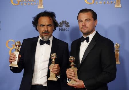 Director Alejandro Gonzalez Inarritu poses with the awards for Best Director and Best Motion Picture - Drama for "The Revenant" (L) and actor Leonardo DiCaprio poses with the award for Best Performance by an Actor in a Motion Picture - Drama for "The Revenant" during the 73rd Golden Globe Awards in Beverly Hills, California January 10, 2016. REUTERS/Lucy Nicholson