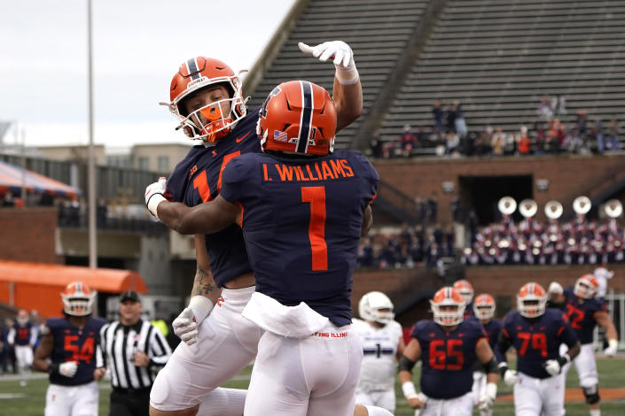 Illinois wide receiver Isaiah Williams (1) celebrates his touchdown with Casey Washington during the first half of an NCAA college football game against Northwestern Saturday, Nov. 27, 2021, in Champaign, Ill. (AP Photo/Charles Rex Arbogast)