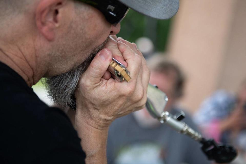 Russ “KidMan” Schenke demonstrates playing the harmonica with an amplifier at a beginners workshop during Make Music Day.