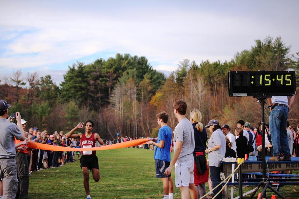 Viraj Deokar of Acton and the Middlesex School cross the finish line at the Independent Schools League cross country meet, setting a course record. Courtesy photo