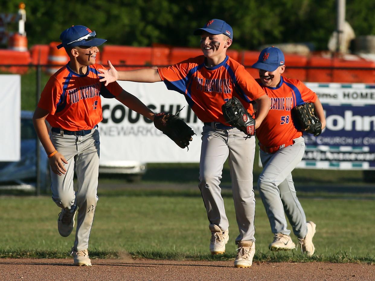 Heath's Ford Electric's Noah Garnack celebrates catching a fly ball during the team's 9-1 loss to Northridge's Hands and Feet Movement in the Licking County Shrine Tournament Varsity Division final at Mound City on Thursday, June 27, 2024.