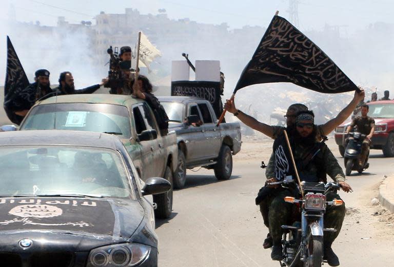 Jihadist fighters from the Al-Nusra Front drive towards the frontline near the northern Syrian city of Aleppo, on May 26, 2015