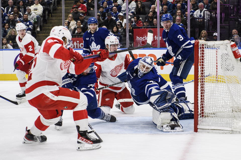 Toronto Maple Leafs goaltender Ilya Samsonov (35) makes a save against Detroit Red Wings right wing Jonatan Berggren (52) during third-period NHL hockey game action in Toronto, Ontario, Sunday, April 2, 2023. (Christopher Katsarov/The Canadian Press via AP)