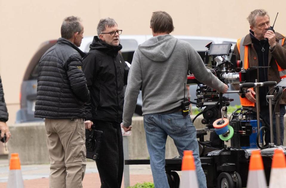Director Paul Thomas Anderson, second from left, confers with crew members during the production of a Warner Bros. movie on Tuesday, Feb. 6, 2024, in downtown Sacramento.