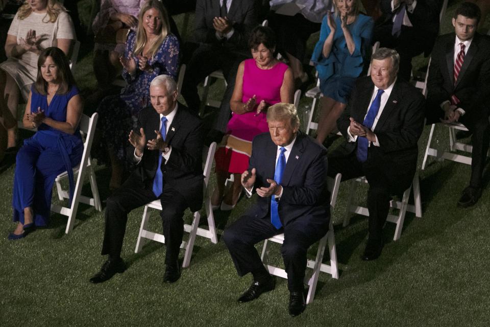 Donald Trump listens to the first lady as she delivers her speech in the Rose Garden (Getty Images)