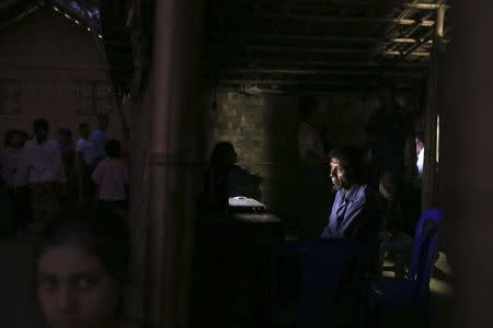 People gather in and around an internet hut in Thae Chaung village, home to thousands of displaced Rohingya Muslims near Sittwe, the capital of Rakhine State in western Myanmar February 15, 2015. REUTERS/Minzayar