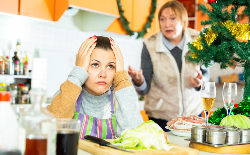 Unhappy senior woman quarreling with daughter during cooking christmas dinner