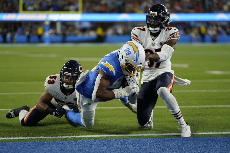 Los Angeles Chargers tight end Donald Parham Jr., center, scores a touchdown as Chicago Bears linebacker T.J. Edwards, left, and safety Duron Harmon defend during the first half of an NFL football game Sunday, Oct. 29, 2023, in Inglewood, Calif. (AP Photo/Ryan Sun)