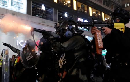 Police officers fire tear gas during a protest in Hong Kong