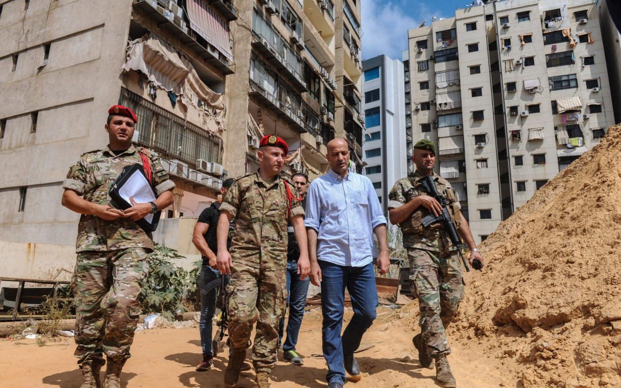 Investigators of Lebanon's military intelligence inspect the site after an alleged attack carried by two Israeli drones, in the southern suburb of Beirut, - REX