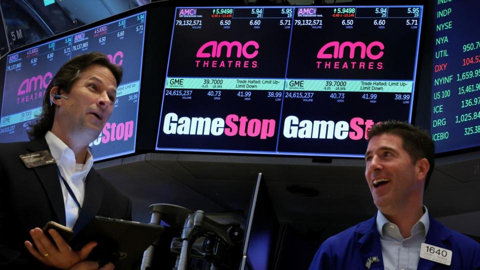  A pair of traders on the NYSE overlooking GameStop. 