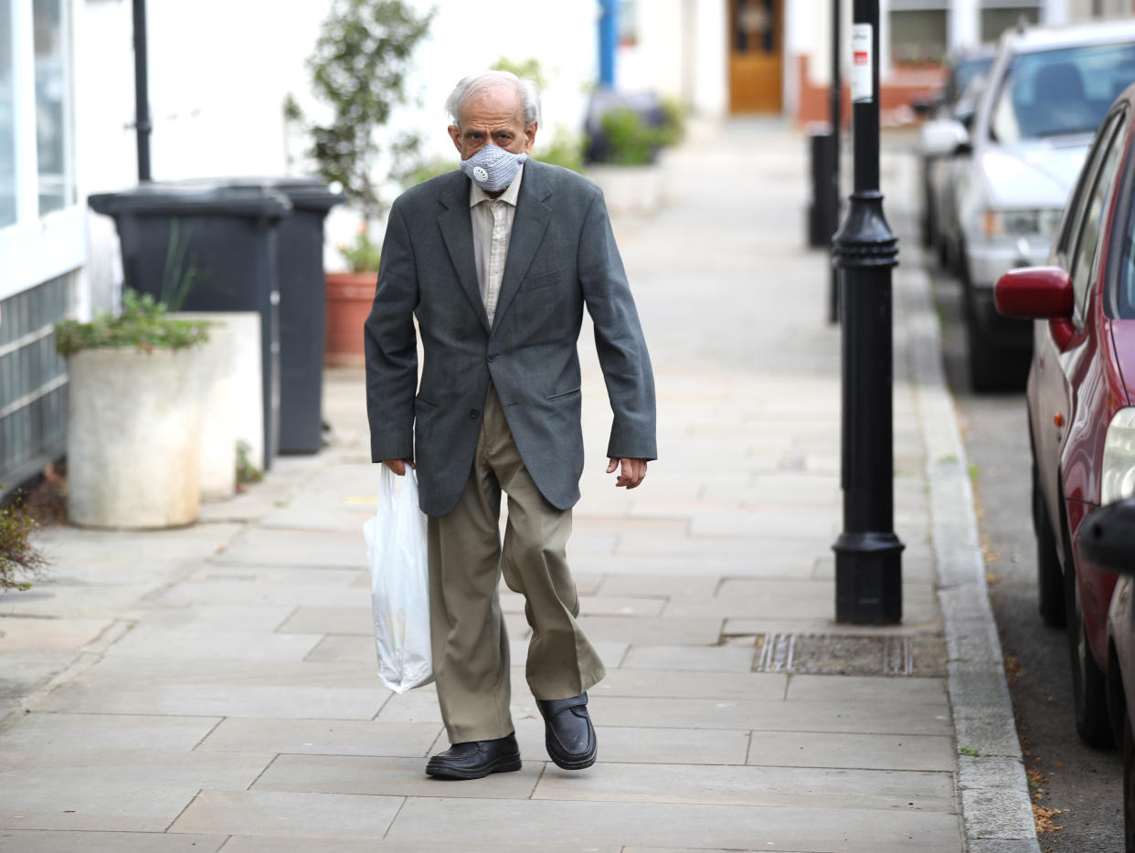 LONDON, ENGLAND - APRIL 11:  An elderly man wearing a face mask walks in Islington on April 11, 2020 in London, England. The Coronavirus (COVID-19) pandemic has spread to many countries across the world, claiming over 100,000 lives and infecting over 1. 7 million people. (Photo by Julian Finney/Getty Images)