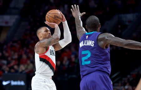 Jan. 11, 2019; Portland, OR, USA; Portland Trail Blazers guard Damian Lillard (0) shoots over Charlotte Hornets forward Marvin Williams (2) during the third quarter at the Moda Center. Mandatory Credit: Craig Mitchelldyer-USA TODAY Sports