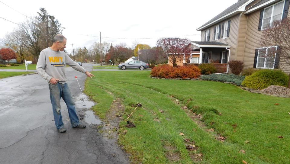 Andrew Trojnar, of Piper Lane, Frankfort, points to the damage to his lawn left behind when a tractor trailer bound for the 5S South Business Park found its way into his residential neighborhood instead.