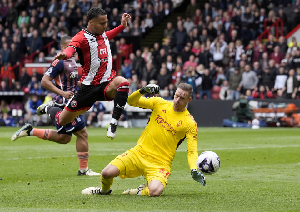 Sheffield United's Cameron Archer, left, vies for the ball with Nottingham Forest goalkeeper Matz Sels, during the English Premier League soccer match between Sheffield United and Nottingham Forest, at Bramall Lane, in Sheffield, England, Saturday May 4, 2024. (Danny Lawson/PA via AP)
