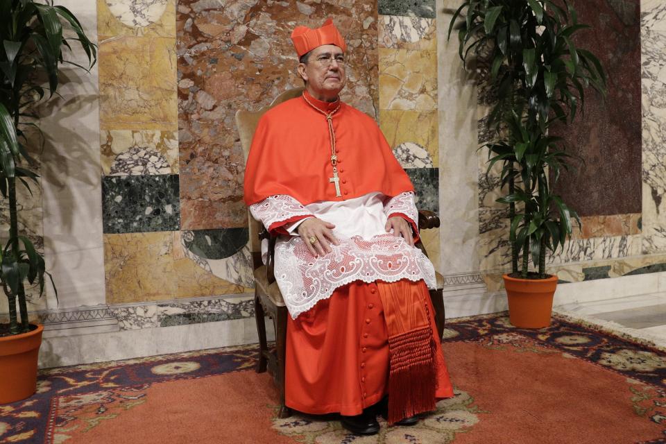 Cardinal Miguel Angel Ayuso Guixot poses for photographers prior to meeting relatives and friends after he was elevated to cardinal by Pope Francis, at the Vatican, Saturday, Oct. 5, 2019. Pope Francis has chosen 13 men he admires and whose sympathies align with his to become the Catholic Church's newest cardinals. (AP Photo/Andrew Medichini)