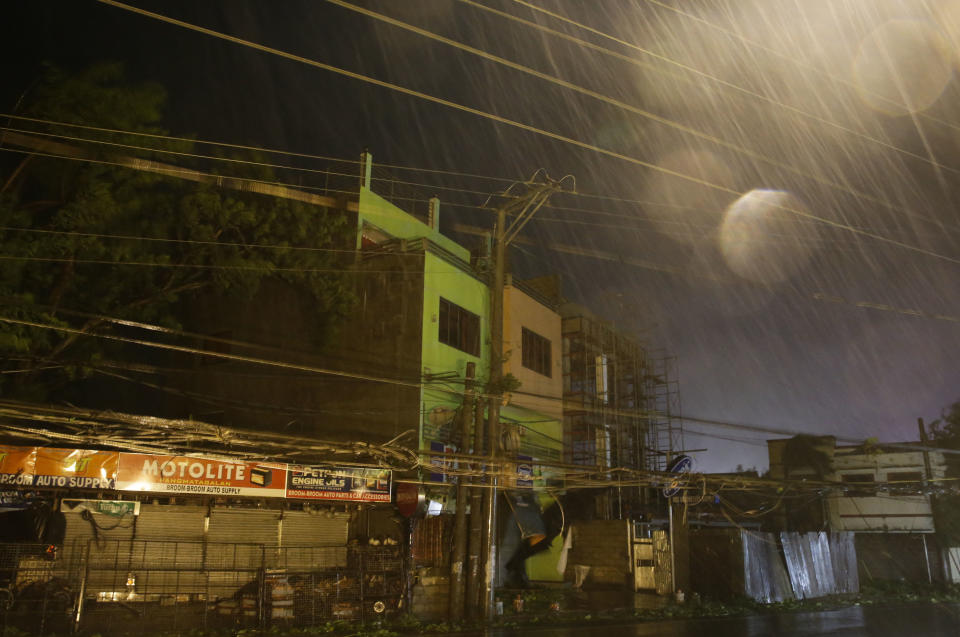 Strong winds and rain batter buildings and business establishments as Typhoon Mangkhut hits Tuguegarao city, Cagayan province, northeastern Philippines on Saturday, Sept. 15, 2018. Typhoon Mangkhut slammed into the country's northeastern coast early Saturday, with witnesses saying the storm's ferocious wind and blinding rain ripped off tin roof sheets and knocked out power at the start of the onslaught. (AP Photo/Aaron Favila)