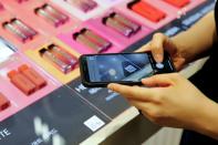 A woman shops using QR code at a cosmetic shop in a department store in Seoul