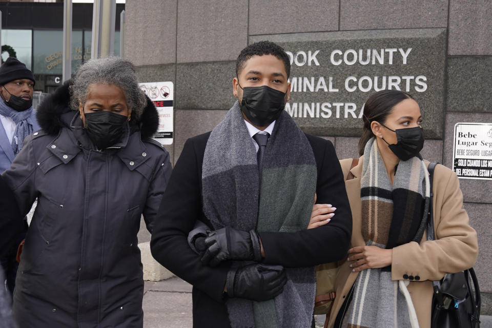 Actor Jussie Smollett, center, departs Tuesday, Dec. 7, 2021, with his mother Janet, left, and an unidentified sister the Leighton Criminal Courthouse after day six of his trial in Chicago. Closing arguments will begin Wednesday, in Chicago. (AP Photo/Charles Rex Arbogast)