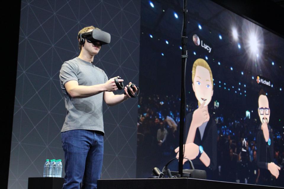 Facebook co-founder and chief executive, Mark Zuckerberg, speaks at an Oculus developers conference while wearing a virtual reality headset in San Jose, California on October 6, 2016. (Photo credit should read GLENN CHAPMAN/AFP via Getty Images)