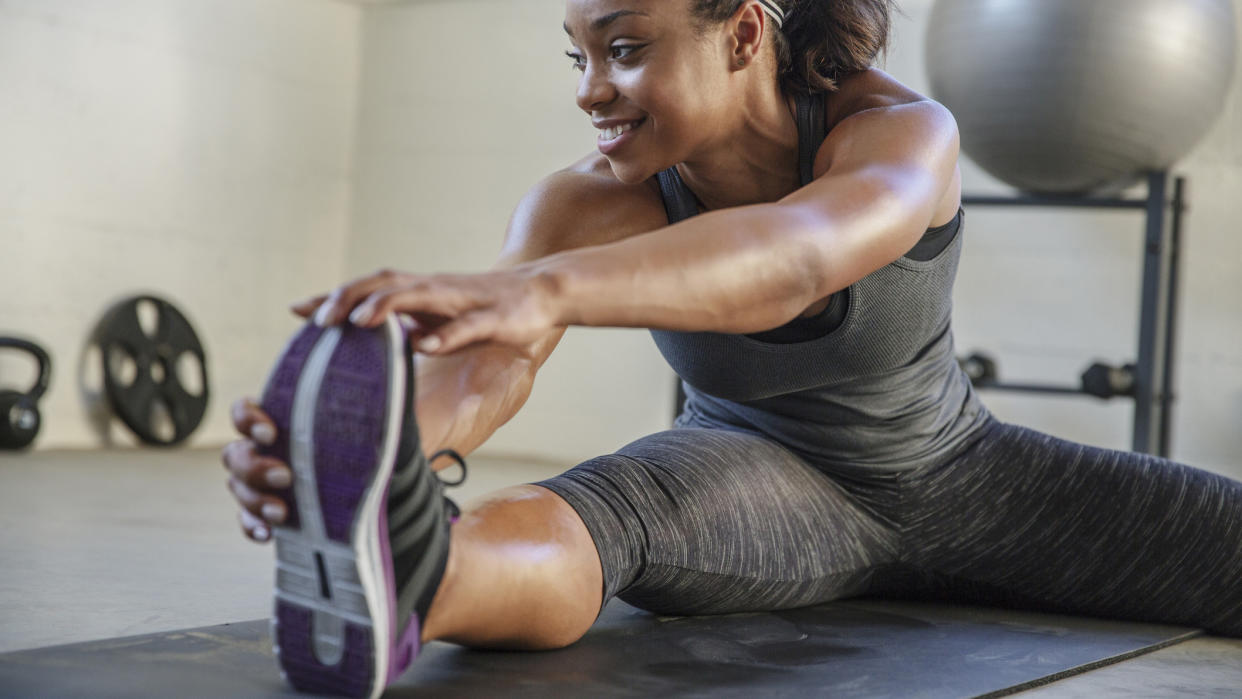  Woman stretching leg before doing a workout. 