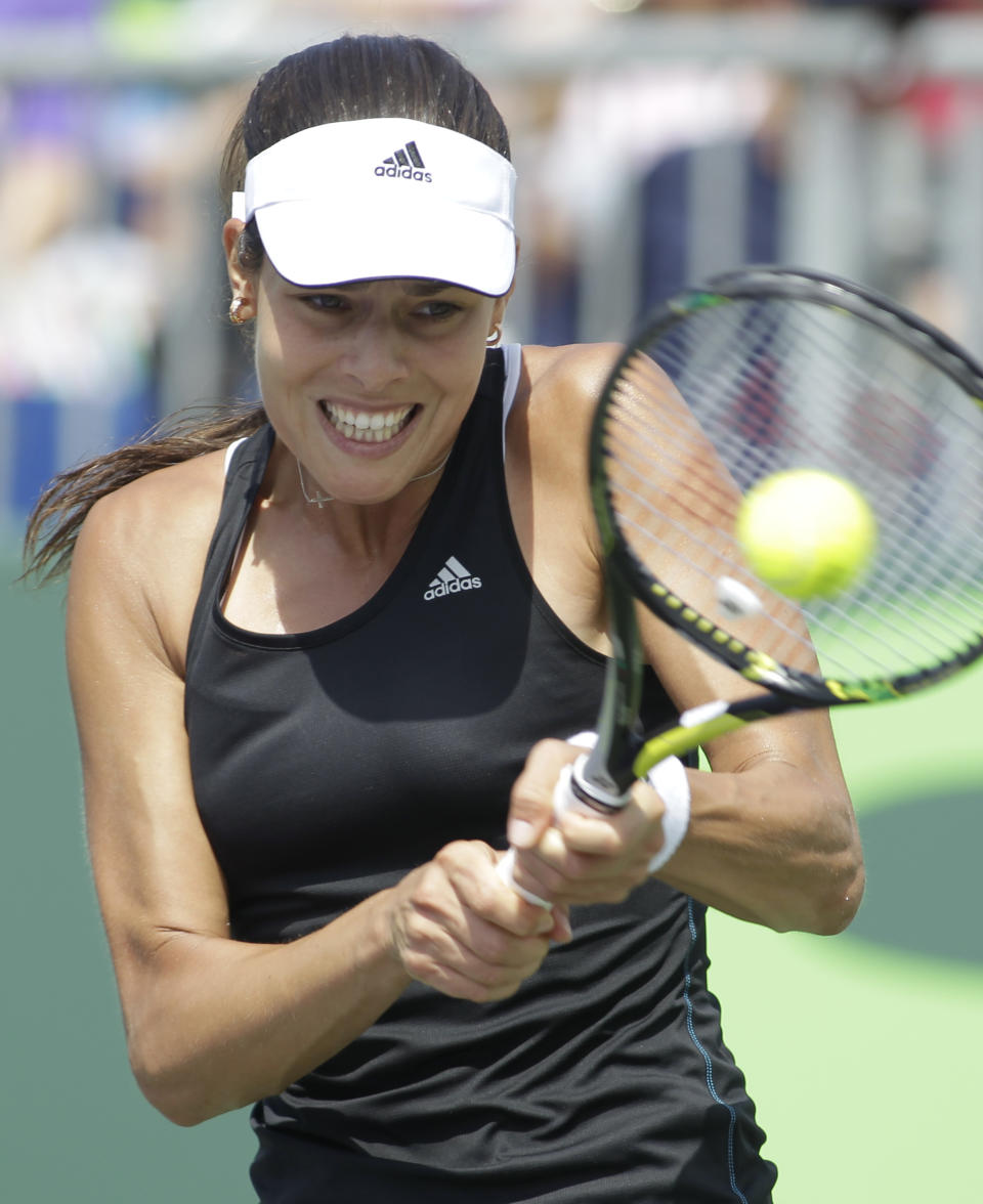 Ana Ivanovic, of Serbia, hits a return to Flavia Pennetta, of Italy, during a match at the Sony Open tennis tournament, Saturday, March 22, 2014, in Key Biscayne, Fla. (AP Photo/Luis M. Alvarez)