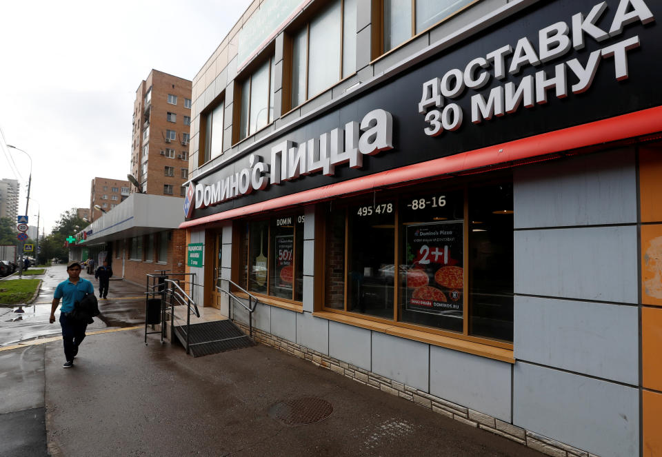 A man walks past a Domino's Pizza restaurant in Moscow, Russia, July 14, 2017. Picture taken July 14, 2017. REUTERS/Sergei Karpukhin