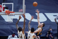 Utah Jazz forward Bojan Bogdanovic, front right, shoots over New Orleans Pelicans forward Brandon Ingram (14) and guard Lonzo Ball (2) in the first half of an NBA basketball game in New Orleans, Monday, March 1, 2021. (AP Photo/Gerald Herbert)