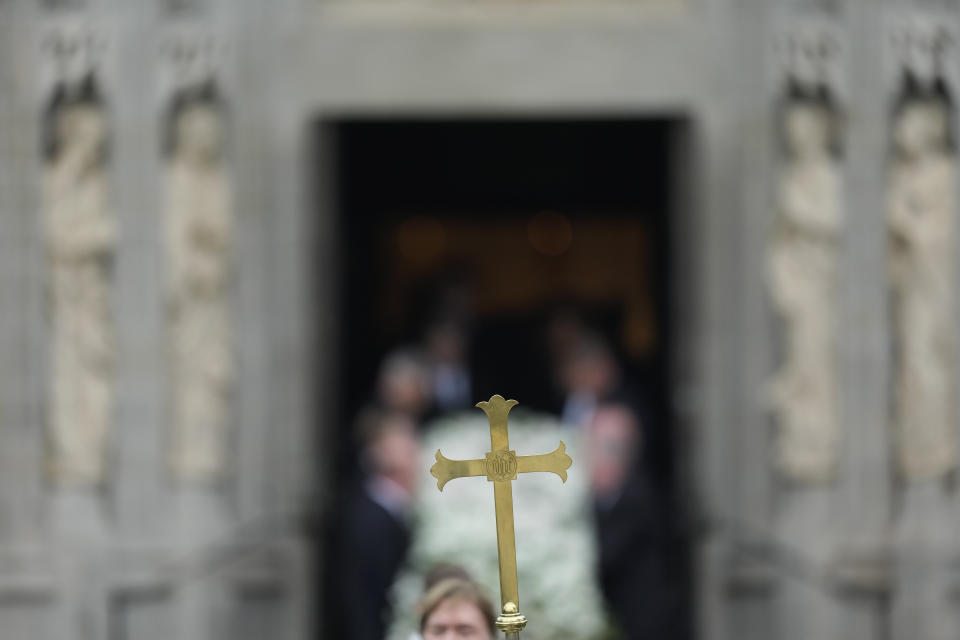 A cross is carried in front of the coffin of former first lady Melania Trump's mother, Amalija Knavs, as it is carried out of the Church of Bethesda-by-the-Sea following a funeral service, Thursday, Jan. 18, 2024, in Palm Beach, Fla. (AP Photo/Rebecca Blackwell)