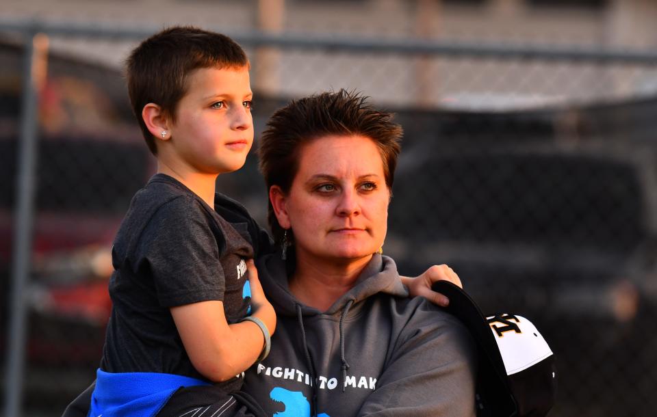 Vivian Sleeth and her mother, Brittany, stand during the national anthem before Friday's baseball game between Merritt Island High and Eau Gallie High.