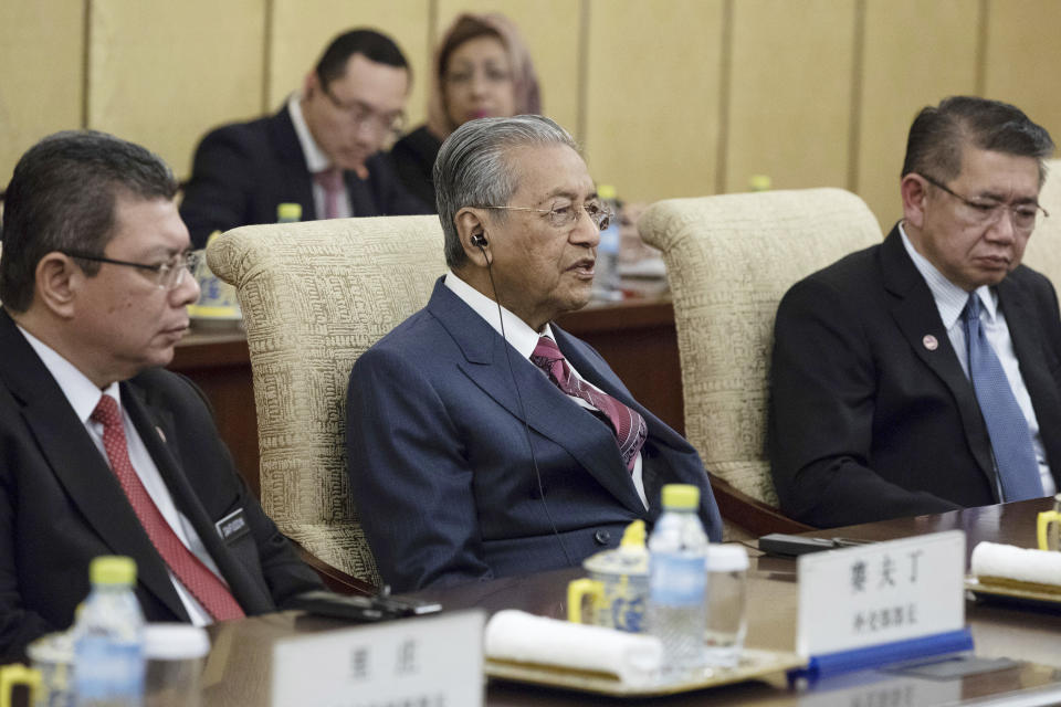 Malaysian Prime Minister Mahathir Mohamad, center, speaks to Chinese President Xi Jinping (not pictured) during their meeting at Diaoyutai State Guesthouse in Beijing, Monday, Aug. 20, 2018. (Roman Pilipey/Pool Photo via AP)