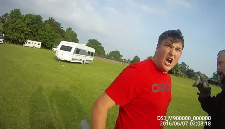 The shocking moment a group of travellers threaten a team of bailiffs (SWNS)